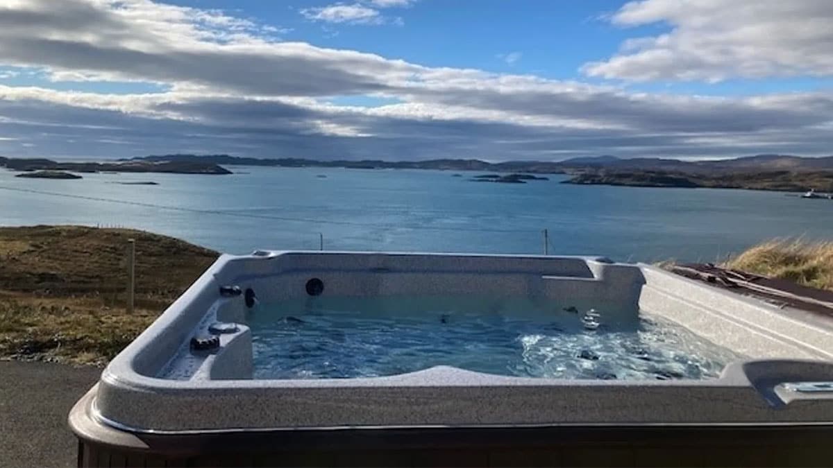 hot tub on decking overlooking sea