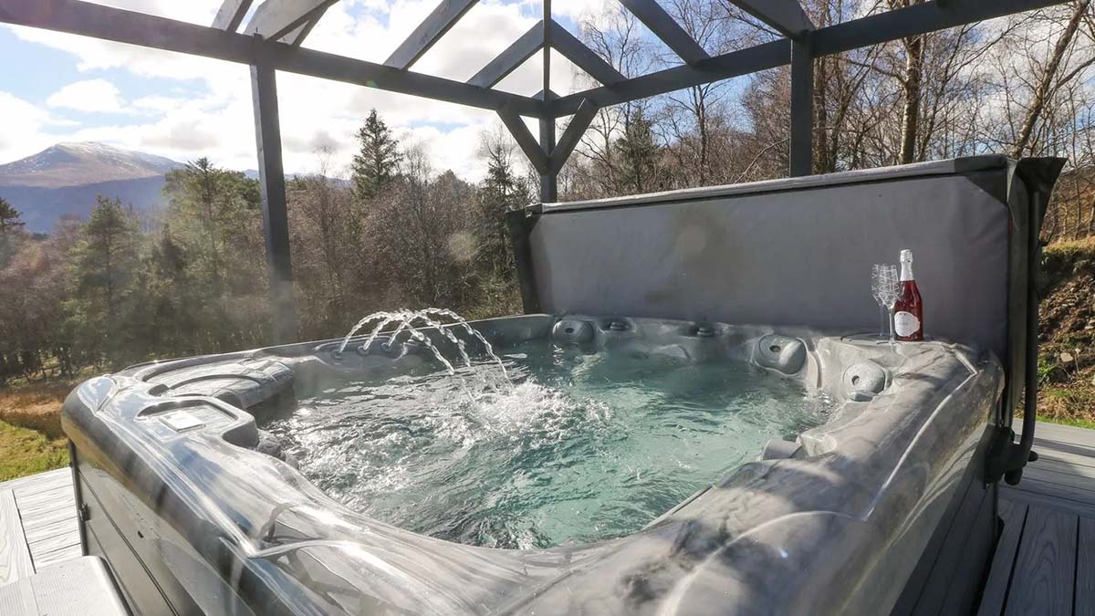hot tub under a roof with mountain views