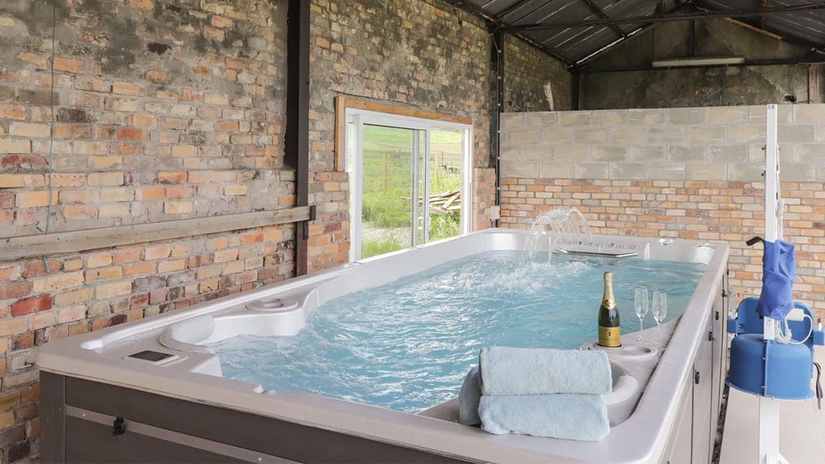 hot tub next to brick wall