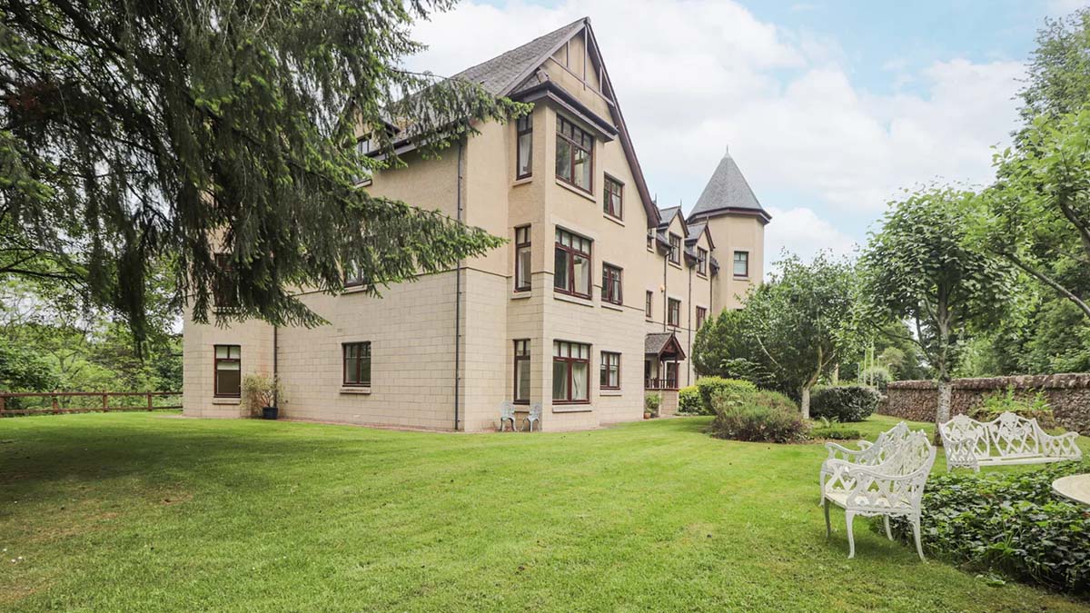 Block of apartments with turret and lawn Inverness