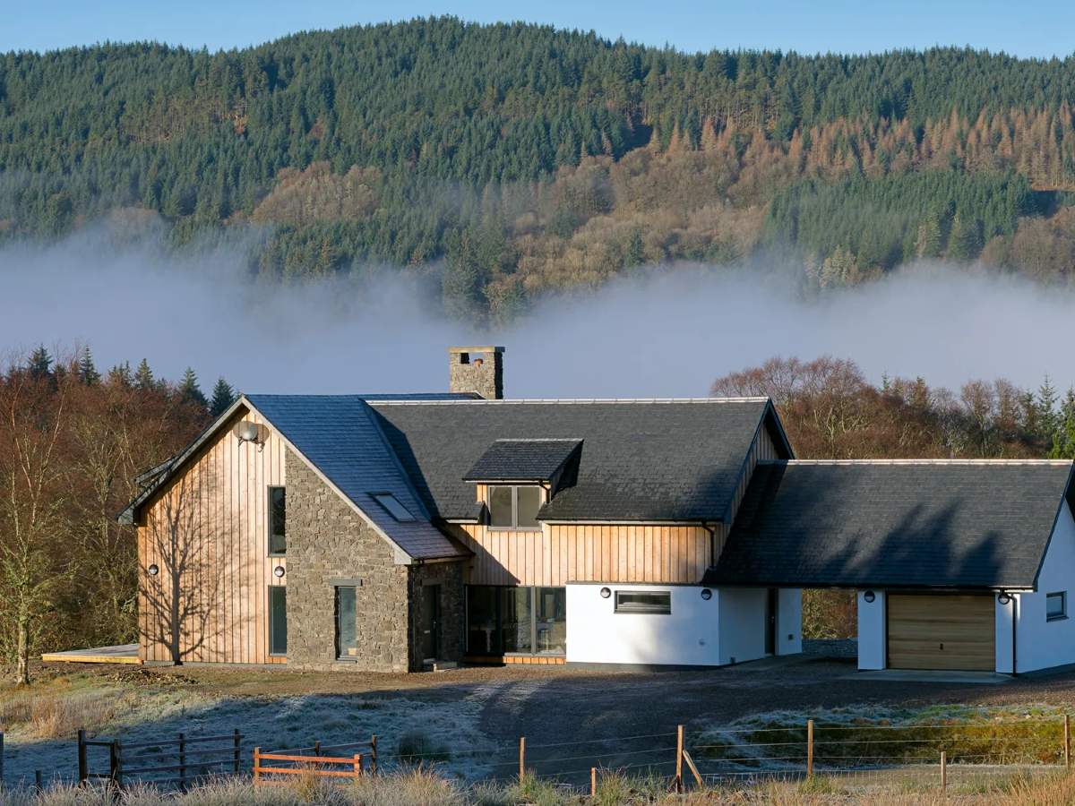 Luxury self-catering cottage in Highlands with hills and forest in background