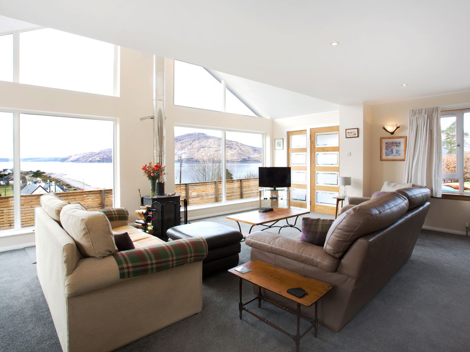 Torgorm Glenelg - lounge with two sofas with views over the sea to the Isle of Skye